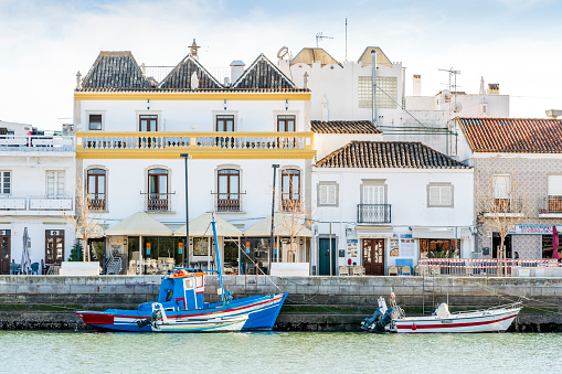 Charming architecture of Tavira with boats on Gilao river, Algarve, Portugal