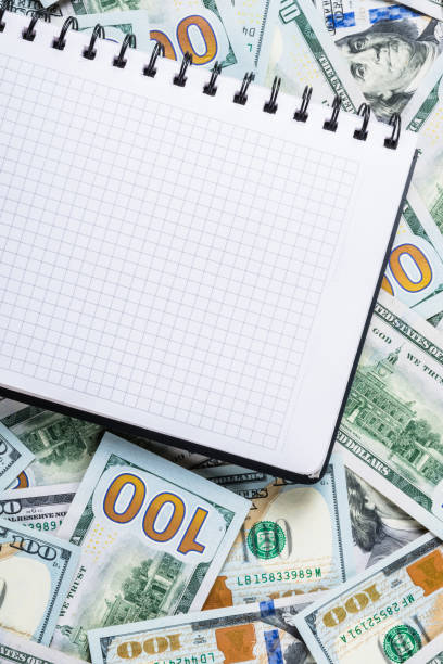 istock Notebook for notes on money background from one hundred dollars 1142183148