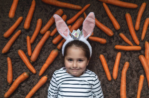 istock Girl and carrots 1142184344