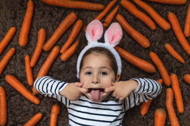 istock Grimacing girl with costume rabbit ears 1142185430