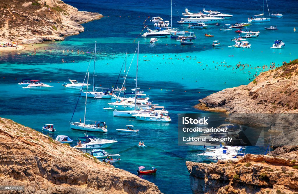 Yachts in blue lagoon at Comino - Malta COMINO, MALTA - JULY 16: Ships at  Blue lagoon at island Comino - Malta on July 16, 2015 in Comino Malta Stock Photo