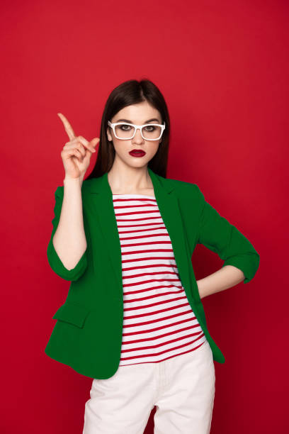 istock Confident stylish brunette lady isolated on red 1142185733