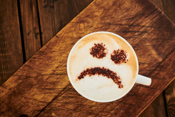 istock Cappuccino Coffee topped with a chocolate unhappy smiley face. 1142185866