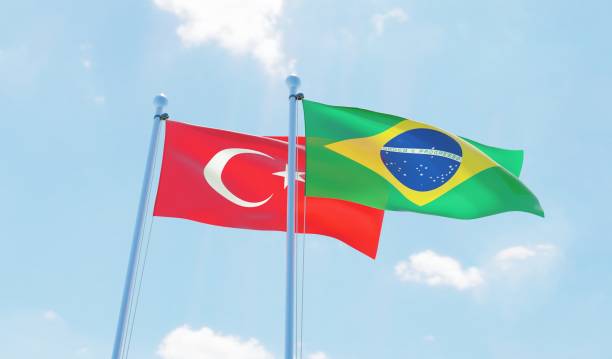 istock Brazil and Turkey, two flags waving against blue sky 1142186040