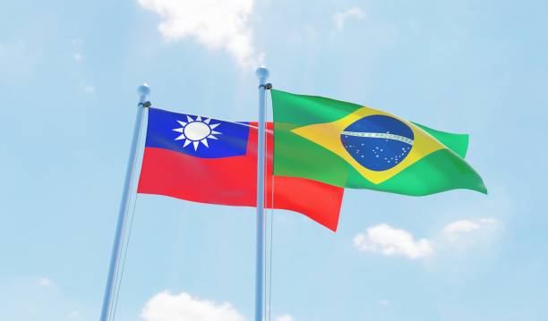 istock Brazil and Taiwan, two flags waving against blue sky 1142186055