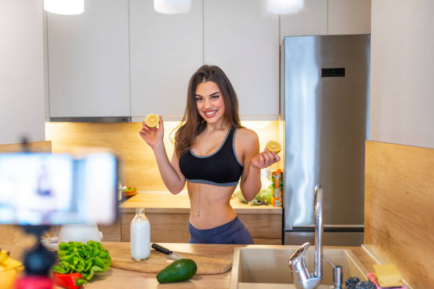 istock Young woman recording food based video content on camera 1142187046