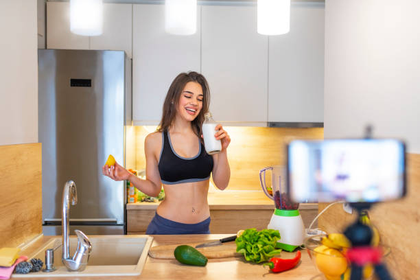 istock Young woman recording food based video content on camera 1142187082