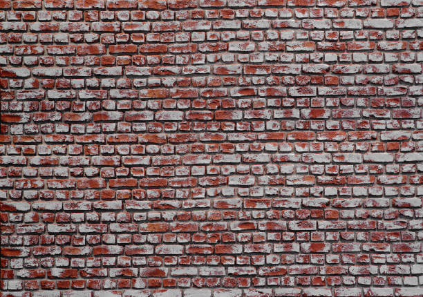 istock Dirty red brick wall with traces of white paint. Brick wall texture background. 1142193623