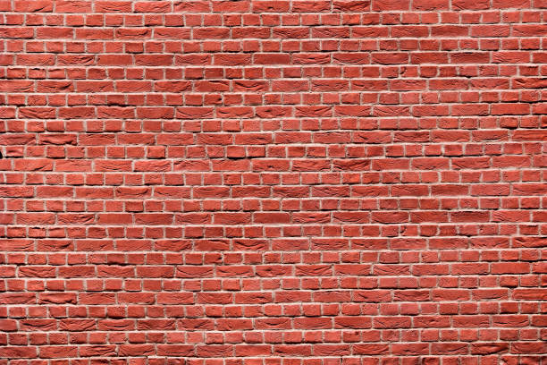 istock Red brick wall with big and small blocks. Brick wall texture background. 1142193635