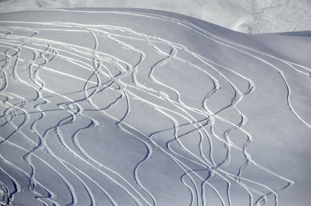 istock Hill with fresh snow covered with snowboard trails. 1142193703