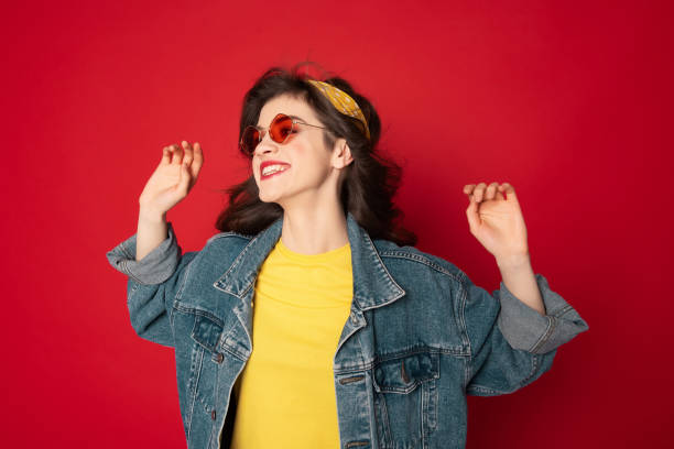 istock Cheerful hipster girl posing isolated on red 1142195617