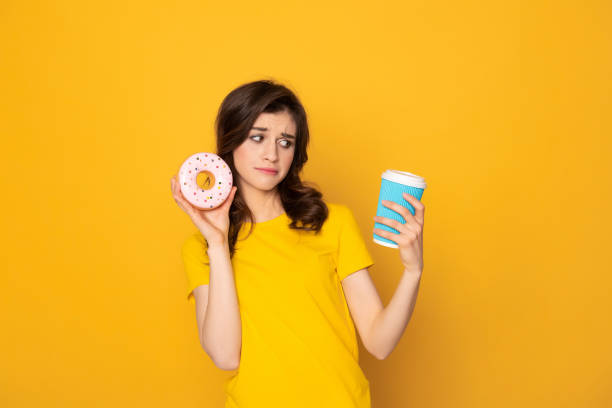 istock Upset girl looking sadly on coffee in hand 1142195675