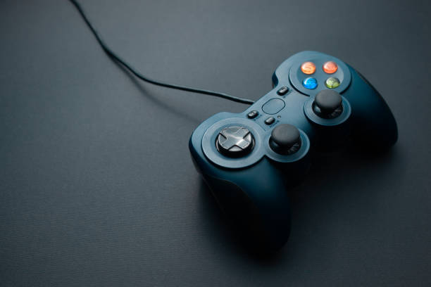 istock Gamepad dark blue with color buttons on a black background 1142195742