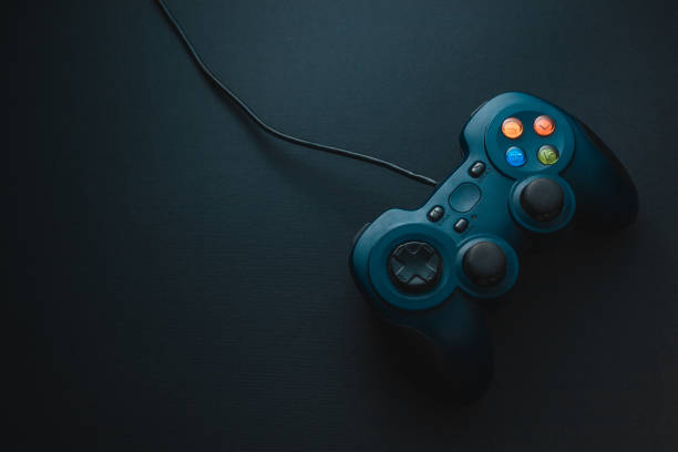 istock Gamepad dark blue with color buttons on a black background 1142195744