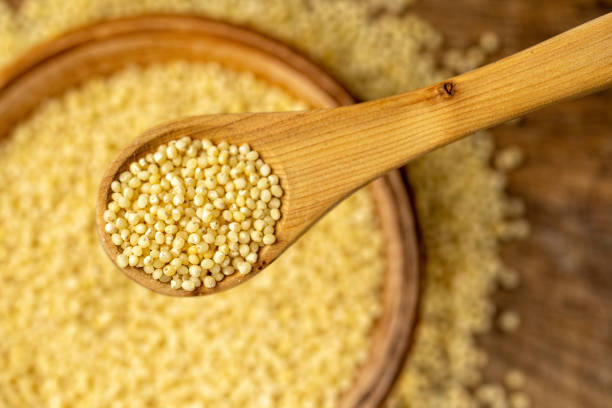istock Millet in spoon above bowl, top view 1142196225
