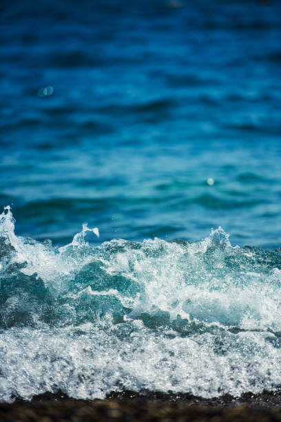 istock Soft Wave Of Blue Ocean On Pebble Beach. 1142197145