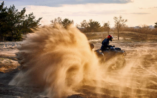 istock Racing in the sand on a four-wheel drive quad. 1142200439