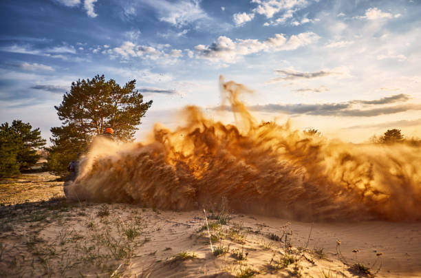 Racing powerful quad bike on the difficult sand in the summer.