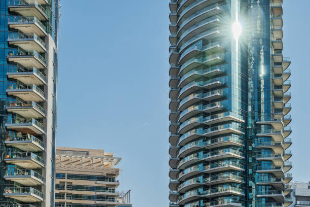 istock View skyscrapers with blue sky and sun reflecting on window. 1142200744
