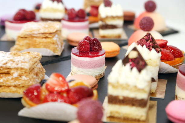 istock Assorted fruit cakes for holiday. Desserts with fruits, mousse, biscuits 1142200756
