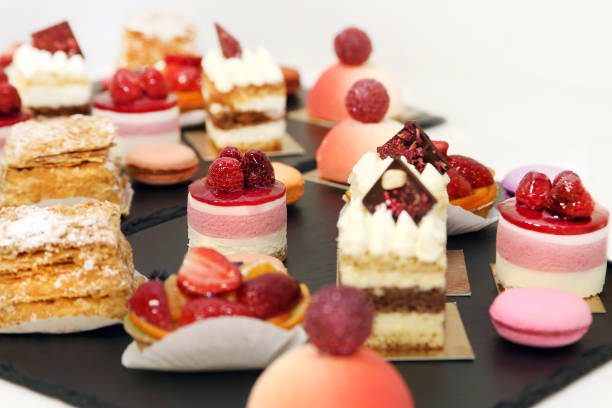 istock Assorted fruit cakes for holiday. Desserts with fruits, mousse, biscuits 1142200758