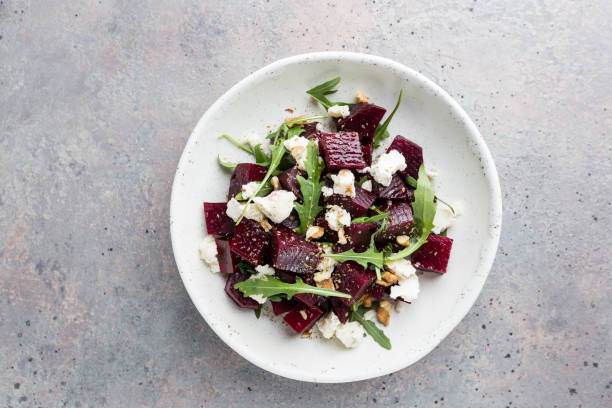 beetroot salad with blue cheese beetroot salad with blue cheese, arugula and walnut in a white plate on gray background, top view cheese goat cheese gourmet food stock pictures, royalty-free photos & images