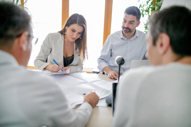 istock Businesswoman in conference room writing data down in notebook 1142201854