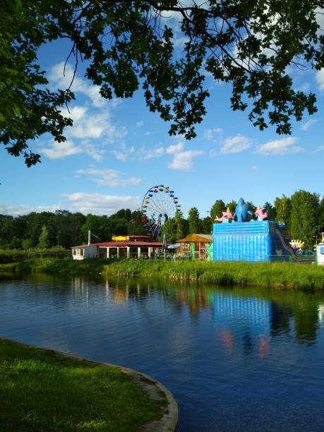 istock Dark blue river, juicy green grass and light blue sky 1142204166
