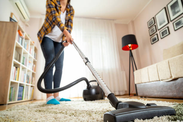 istock Woman vacuuming house 1142204219