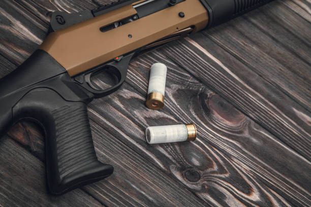 istock Brown black shotgun on a wooden background 1142205275