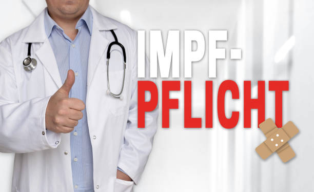 Impfpflicht (in german Vaccination) concept and doctor with thumbs up