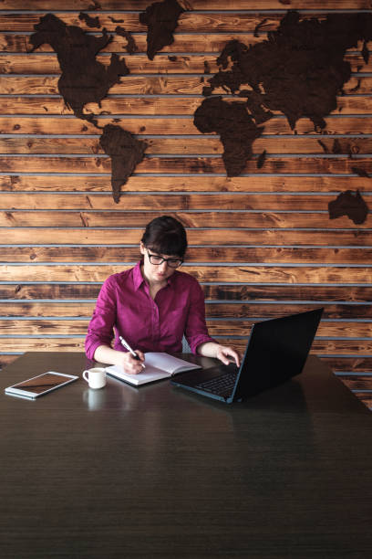 istock Businesswoman taking notes as she works 1142205464