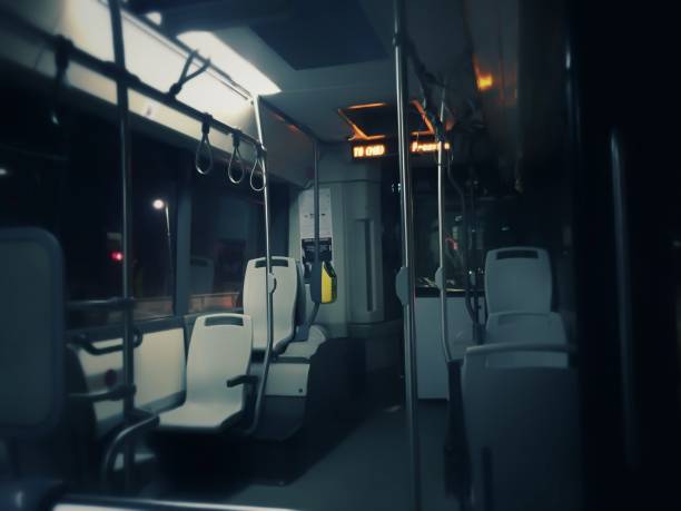 Interior of a public transport bus in Rome with empty gray plastic seats