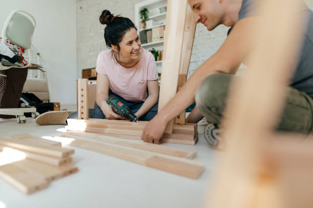 Couple assembling furniture together