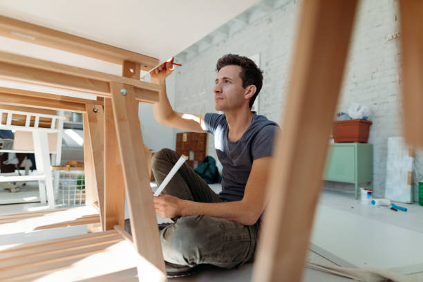 istock Young man measuring desk during furniture assembling 1142206981