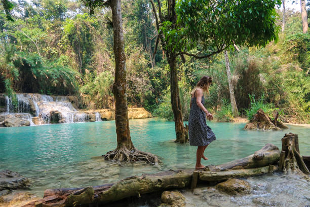 istock Woman waling through a log, waterfall 1142207084
