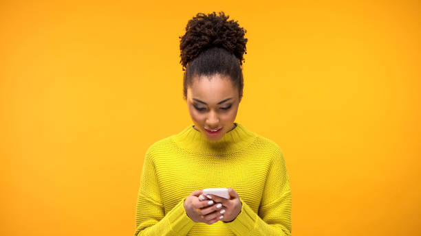 istock African-American woman using smartphone, online banking application, device 1142207487