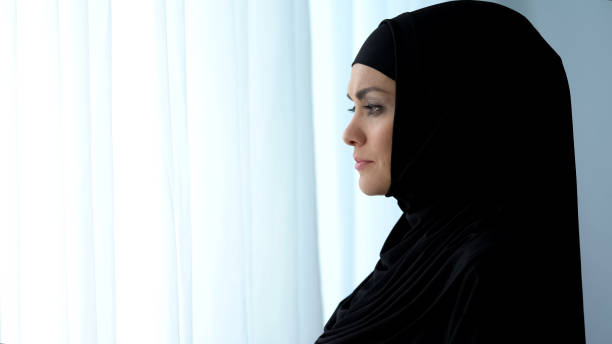 istock Attractive lady in hijab looking window, islamic obedience, waiting for husband 1142208518