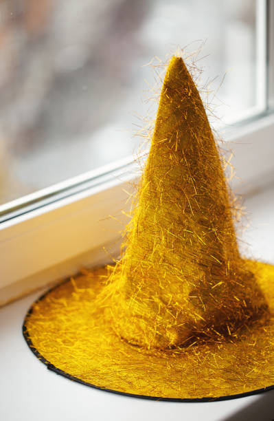 yellow glitter hat on windowsill yellow glitter hat on windowsill happy end stock pictures, royalty-free photos & images