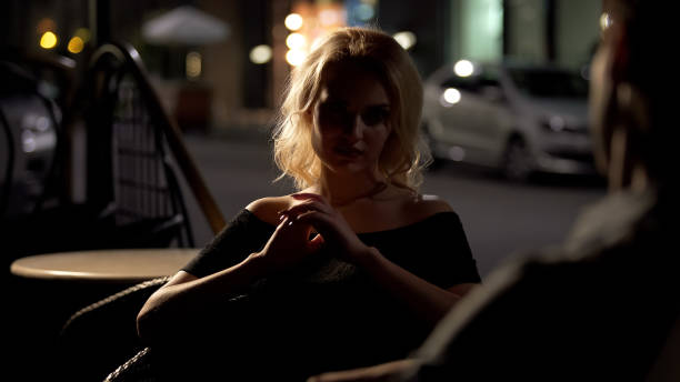 istock Beautiful female sitting at restaurant and talking with man, evening time 1142209566