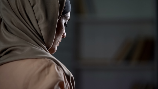 Unhappy arab woman in hijab close-up, pessimistic mood, sorrow, melancholy