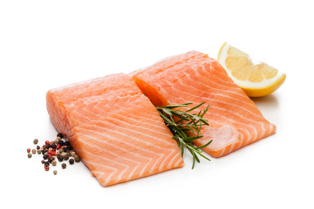 two raw salmon fillets isolated on white background - lemon food preparation portion imagens e fotografias de stock