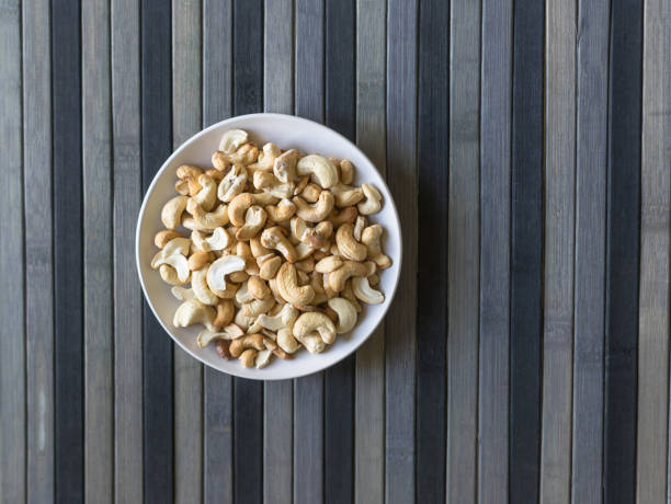 Healthy food  for background image close up cashew nuts.  Nuts texture on top view on the cup plate