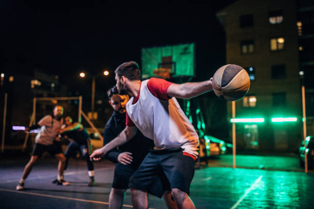 istock Group of friends playing basketball 1142215468