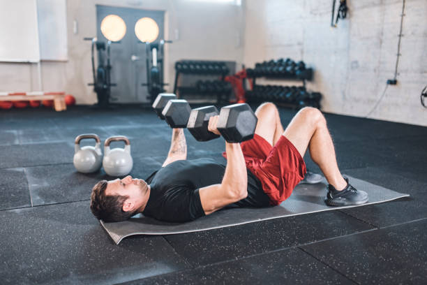 istock Caucasian man doing exercises for the chest using dumbbels 1142215472
