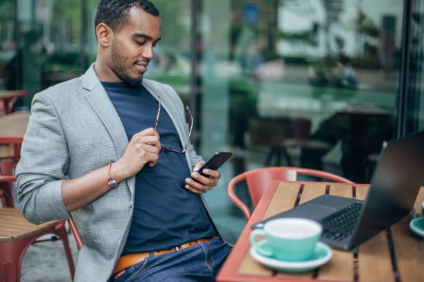 istock Man sitting in coffee shop and using phone 1142218749