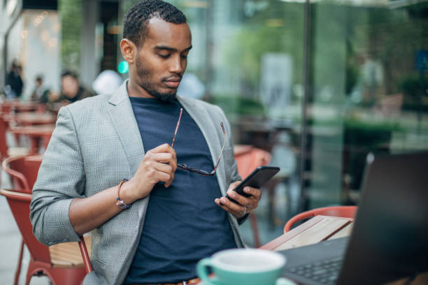 istock Man using phone in coffee shop 1142219282
