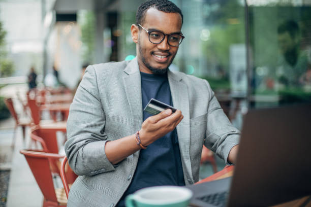 istock Man sitting in coffee shop and using laptop 1142219307