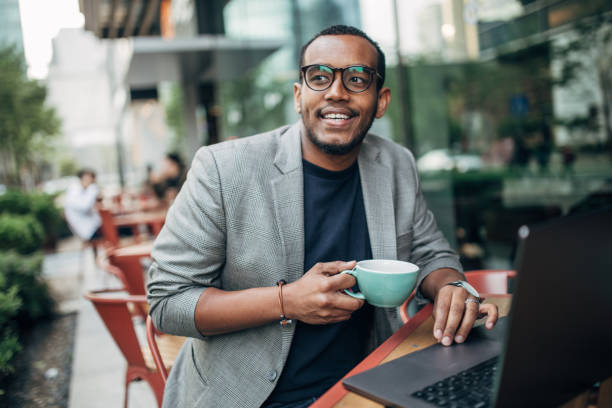 istock Young man sitting in coffee shop and using laptop 1142219332