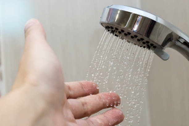 istock hand in the shower test water temperature 1142219836